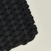 Closeup view of woven doormat in charcoal