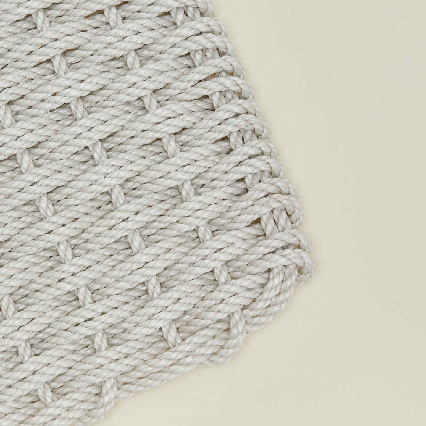Close up view of woven doormat in oyster