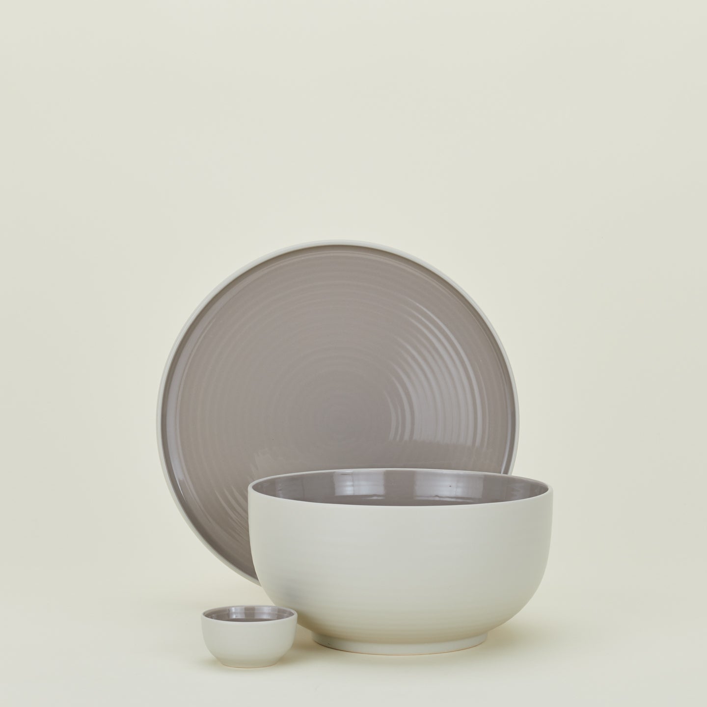 Group of Essential serving pieces in Light Grey including bowl, platter and extra small bowl.